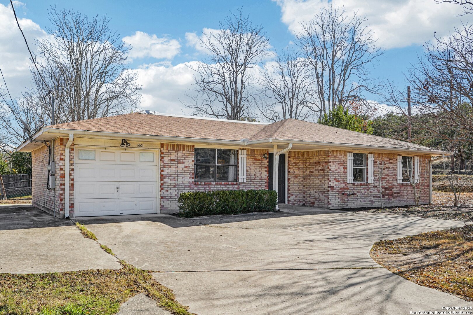 1601 Newton Street Kerrville, TX 78028 - Photo 2 of 23 a front view of a house with a yard