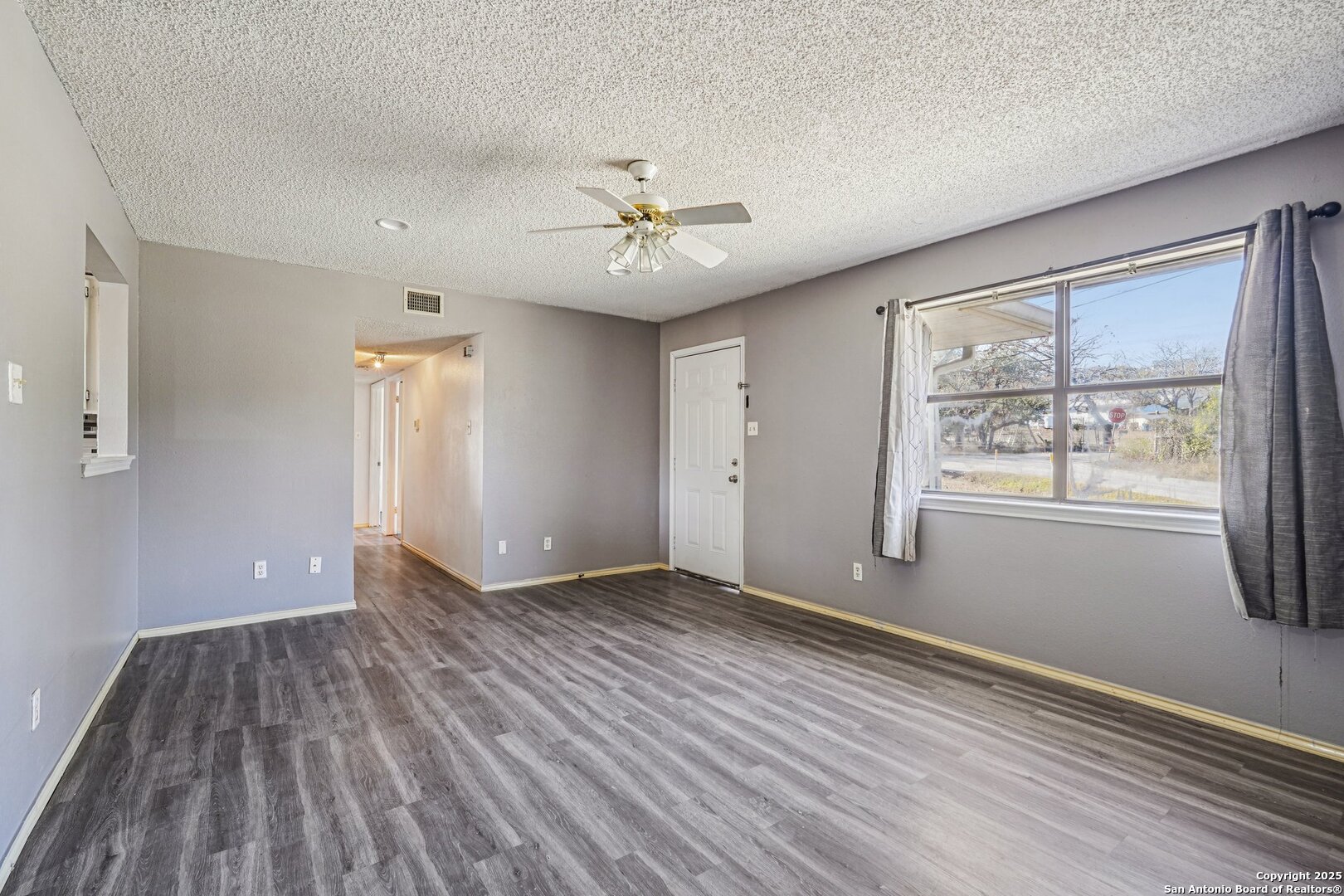 1601 Newton Street Kerrville, TX 78028 - Photo 5 of 23 wooden floor in an empty room with a window