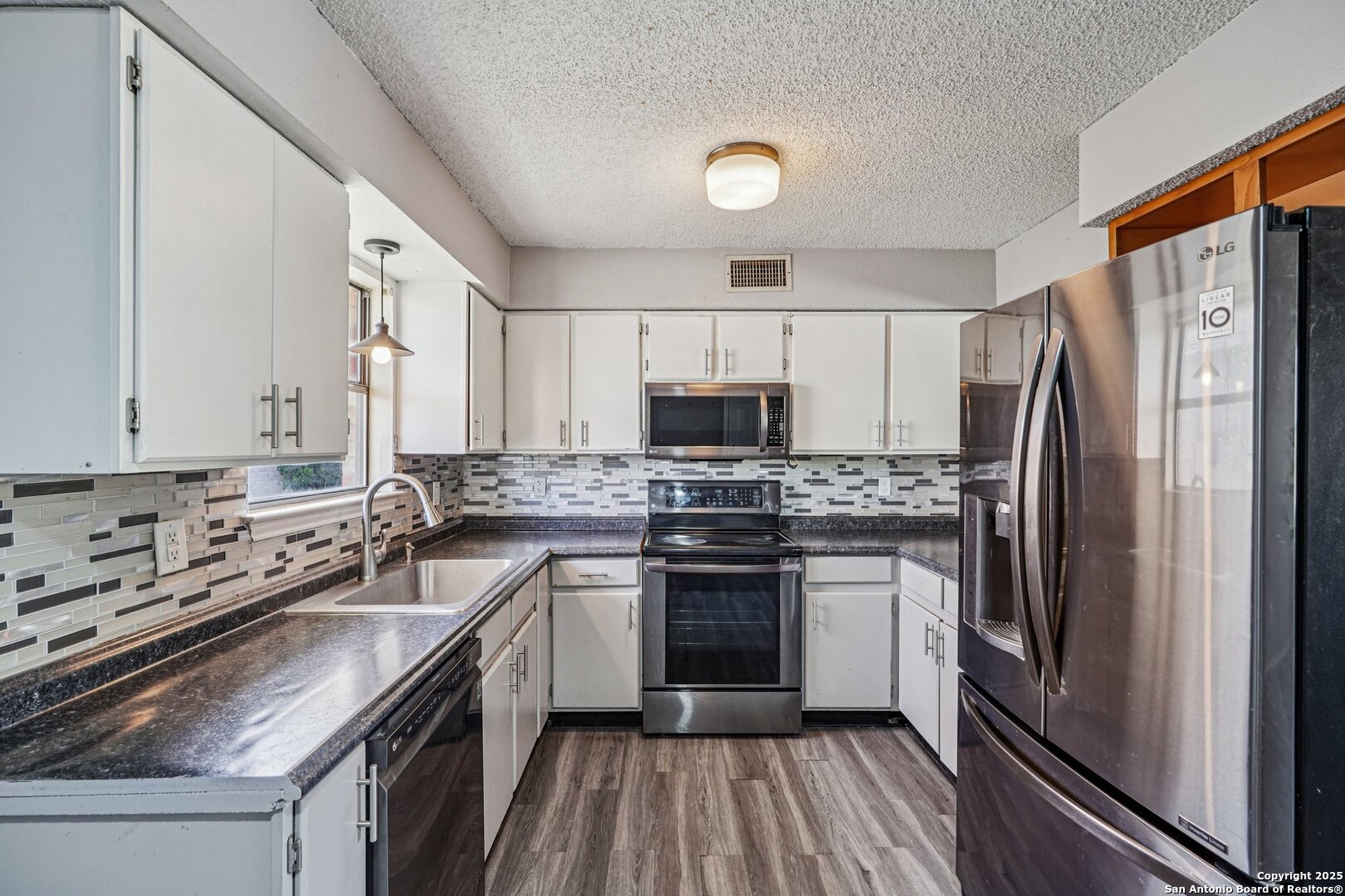 1601 Newton Street Kerrville, TX 78028 - Photo 9 of 23 a kitchen with a sink stove and refrigerator