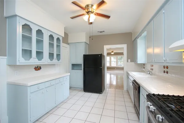 a bathroom with a window sink and cabinets