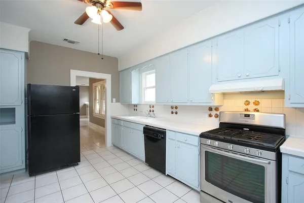 a kitchen with a sink cabinets and window