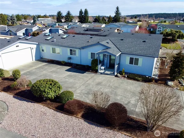 a aerial view of a house with a yard street and seating space