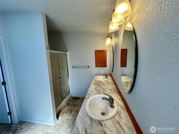 an entryway with wooden floor and mirror