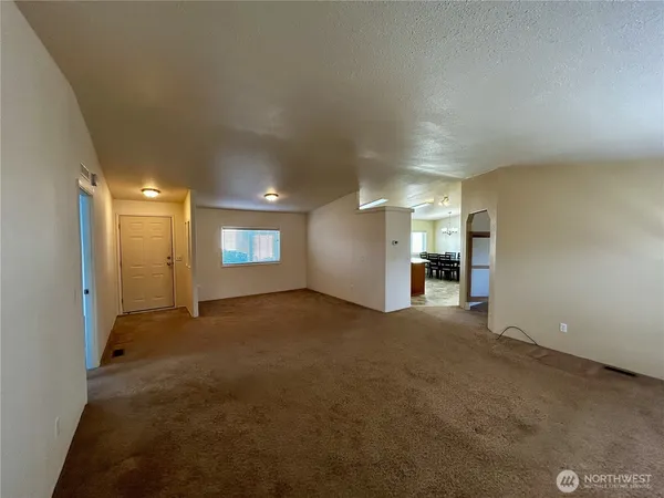 a view of a big room with closet and windows