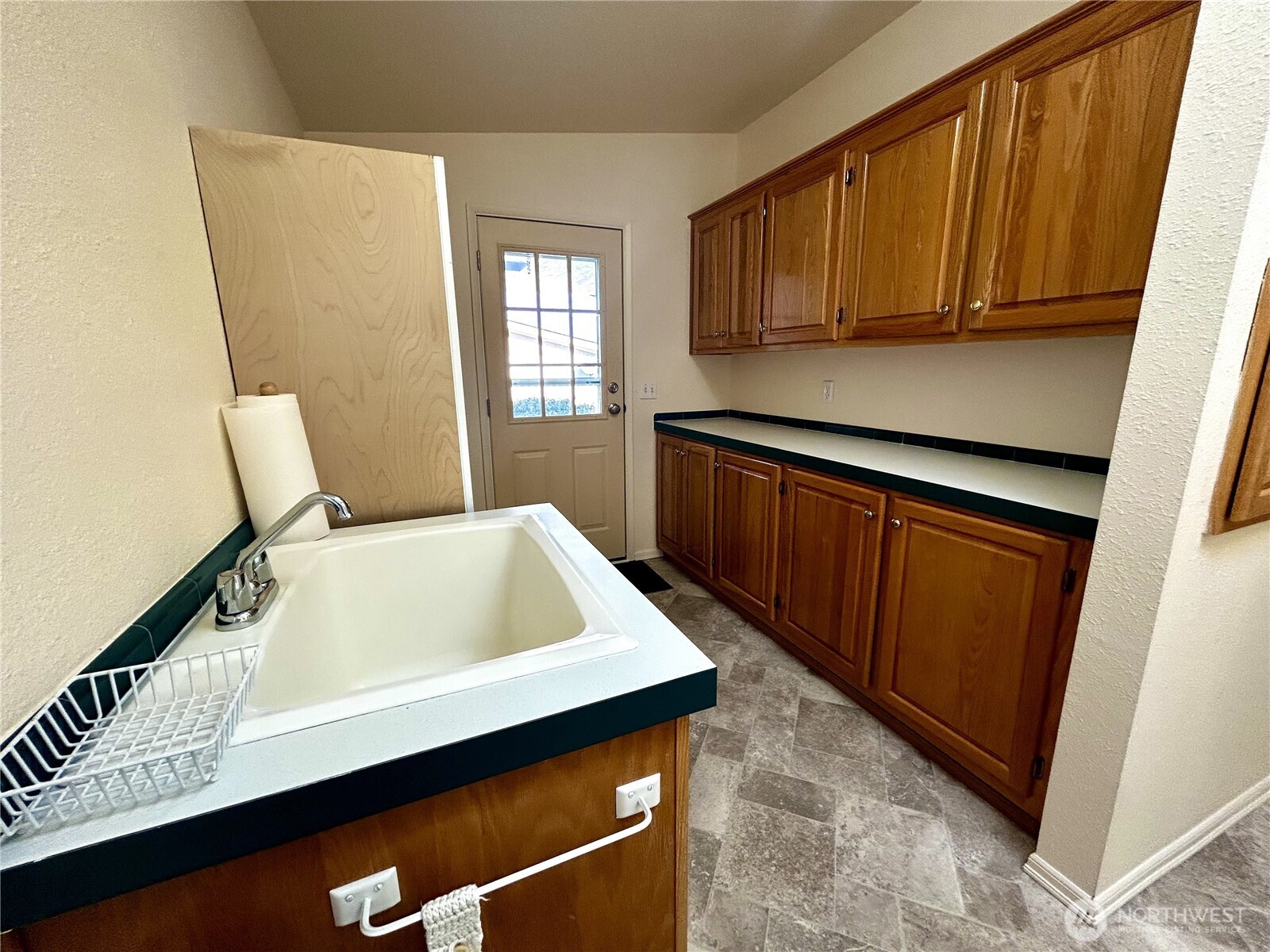 420 Cove Lane Sequim, WA 98382 - Photo 21 of 33 a kitchen with a sink a stove cabinets and a window