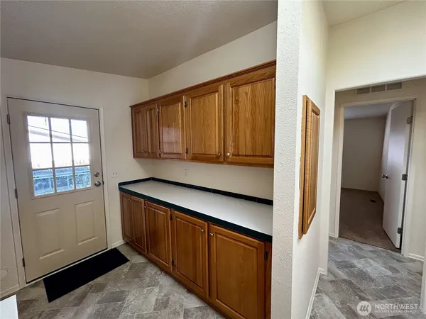a kitchen with window and cabinets