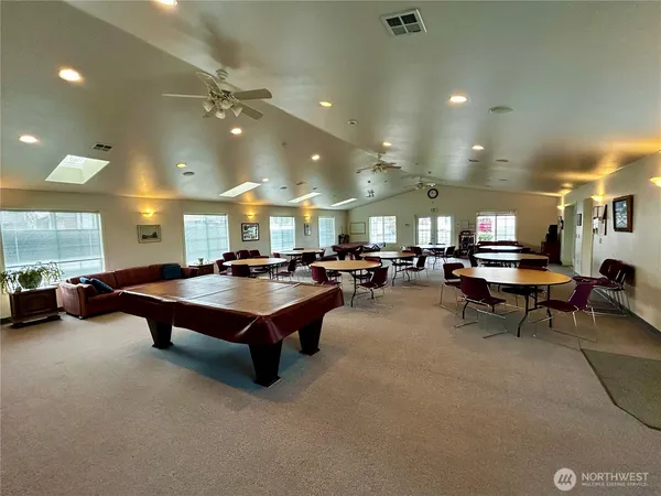 a room with lots of furniture and a chandelier