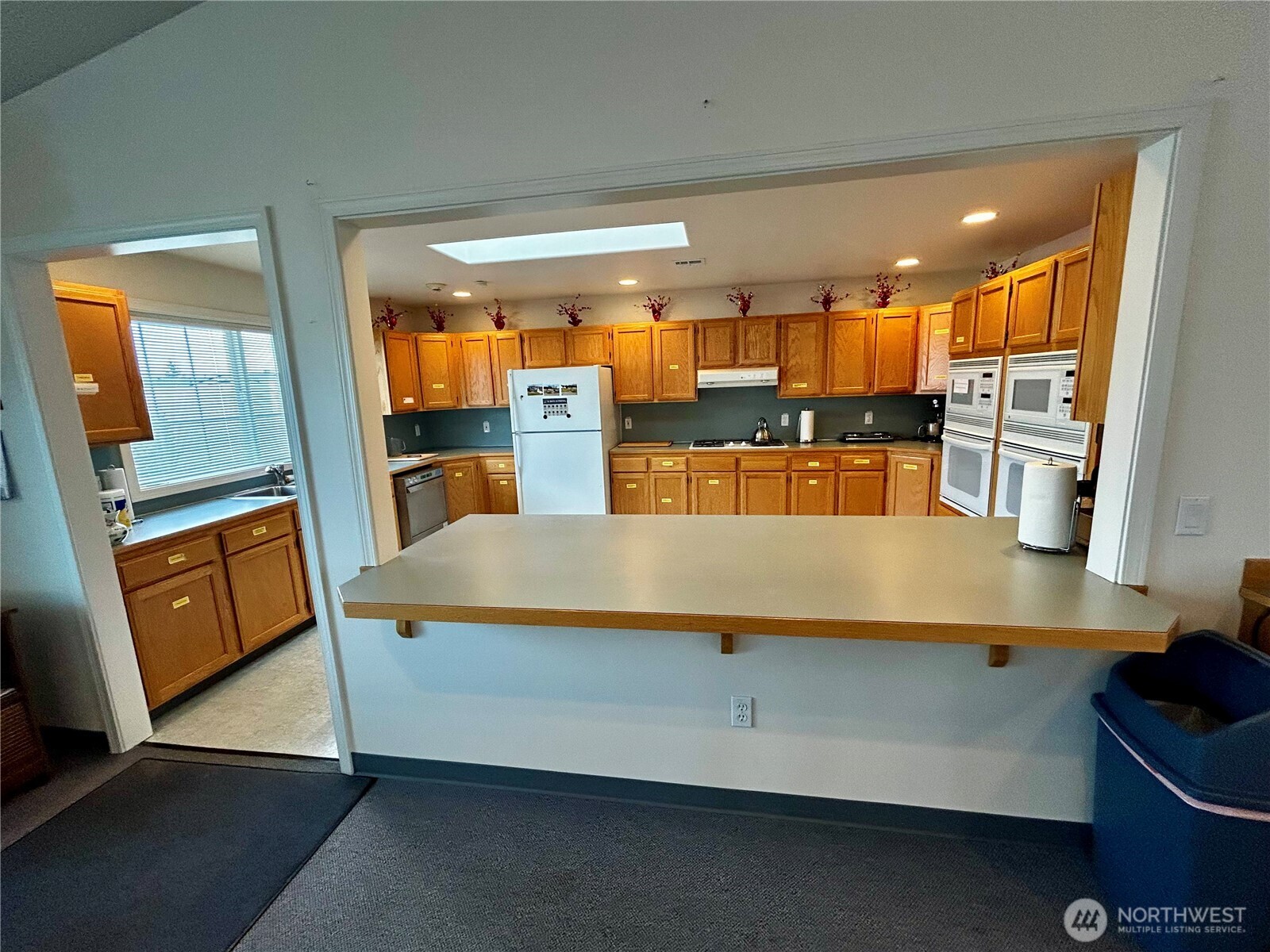 420 Cove Lane Sequim, WA 98382 - Photo 32 of 33 a kitchen with stainless steel appliances kitchen island sink refrigerator and stove