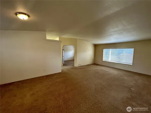 an empty room with a empty space and windows