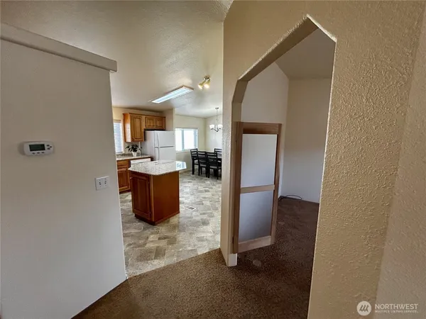 a view of a kitchen from the hallway