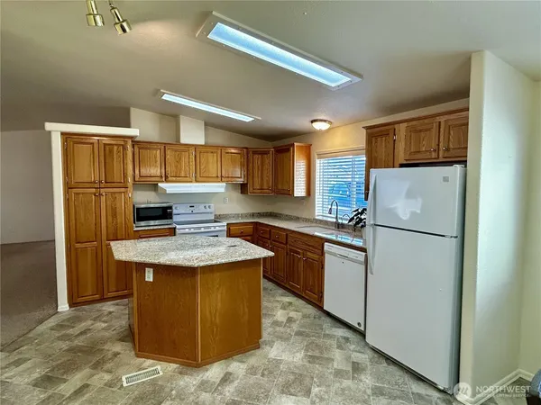 a kitchen with refrigerator and cabinets