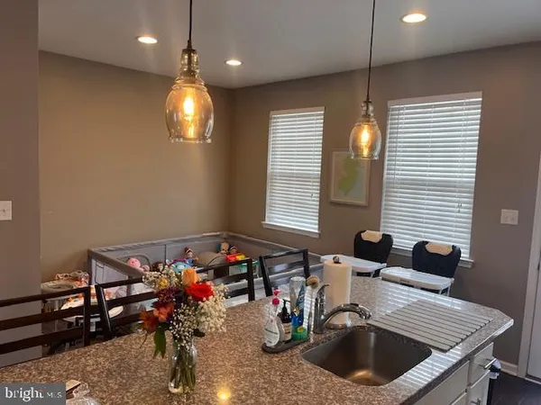 a view of a dining room with furniture and a chandelier