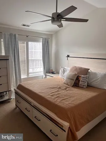 a bedroom with a bed and a window