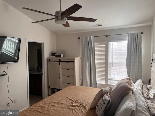 a bedroom with a bed and a flat tv screen