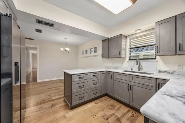 a bathroom with a granite countertop toilet sink and mirror