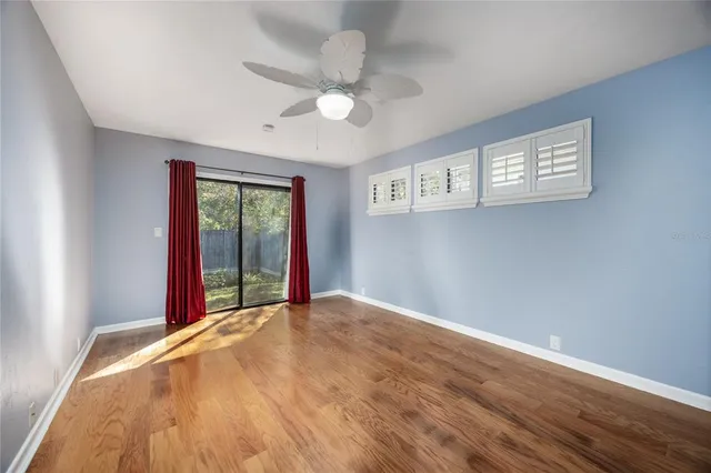 a view of a house with a window and wooden fence