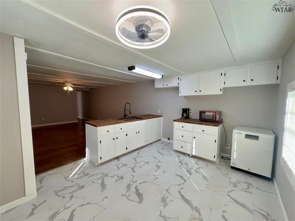 a kitchen with a stove a sink and a refrigerator