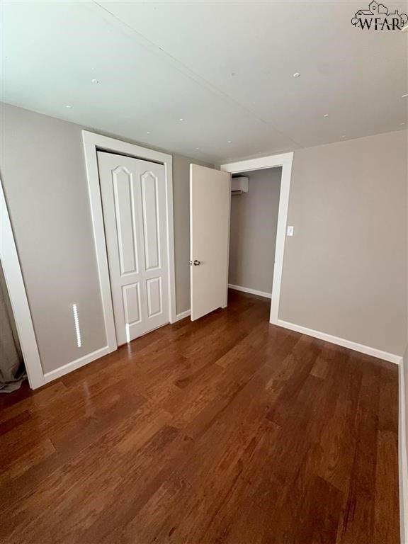 106 Patterson Street Wichita Falls, TX 76301 - Photo 13 of 20 an empty room with wooden floor and windows