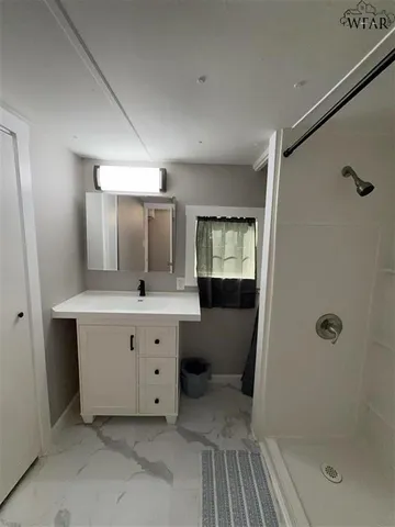 a bathroom with a tub sink and mirror