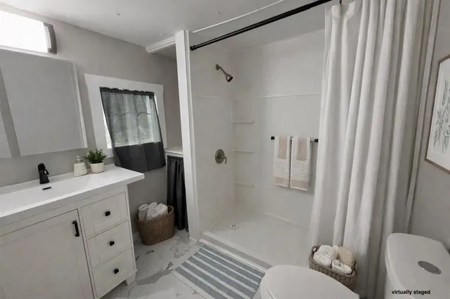 a bathroom with a sink toilet and shower