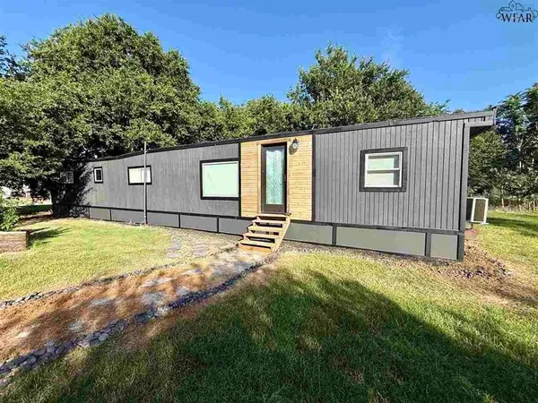 a view of backyard of house with trees