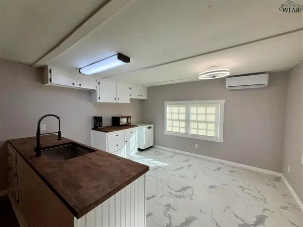 a kitchen with granite countertop a sink a stove and a refrigerator