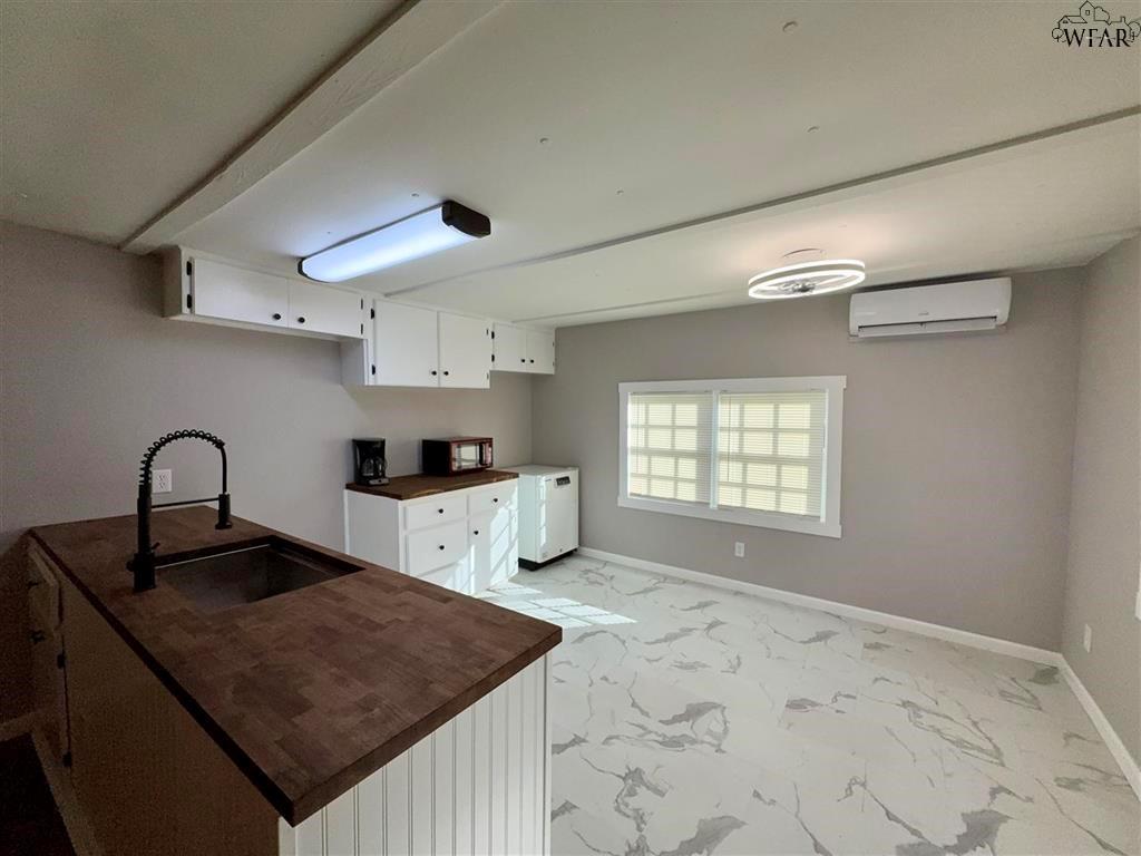 106 Patterson Street Wichita Falls, TX 76301 - Photo 10 of 20 a kitchen with granite countertop a sink a stove and a refrigerator