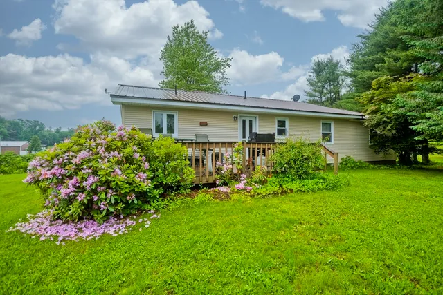 a view of a house with a garden and plants
