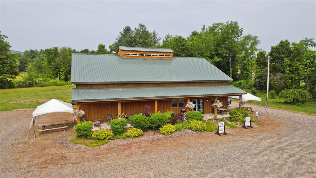 336 Russellville Road Westfield, MA 01085 - Photo 6 of 18 a sign that is sitting in front of a house with potted plants