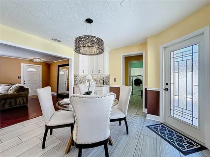 a view of a dining room with furniture window and wooden floor