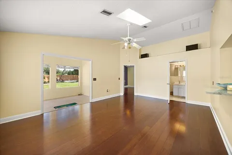 a view of an empty room with wooden floor