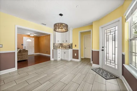 a view of a kitchen with kitchen island granite countertop wooden floor and a sink
