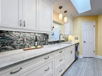 a kitchen with sink and cabinets