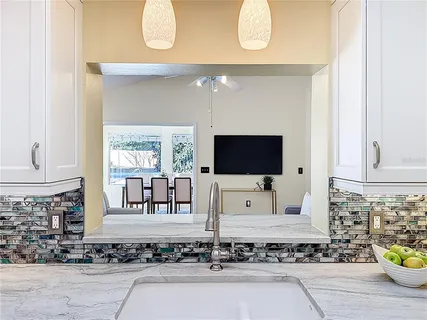 a living room with a fireplace and a flat screen tv