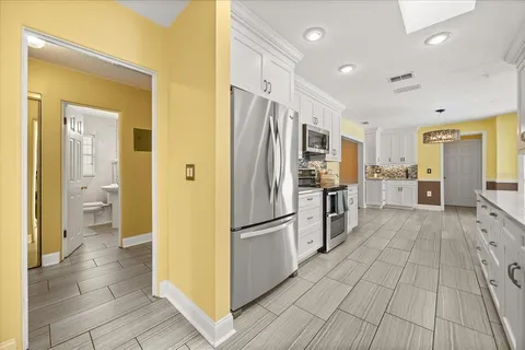 a kitchen with a refrigerator and a sink
