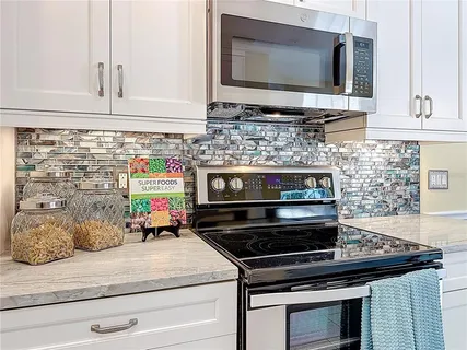 a kitchen with stainless steel appliances and cabinets