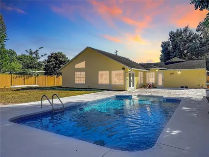 a view of a swimming pool with lounge chair