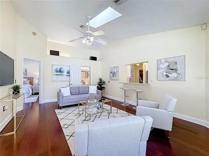 a living room with furniture or wooden floor and a chandelier