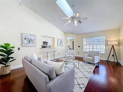 a living room with furniture and wooden floor