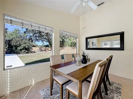 a view of a dining room with furniture window and outside view