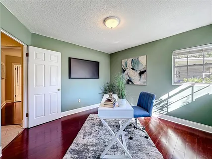 a living room with furniture and a wooden floor