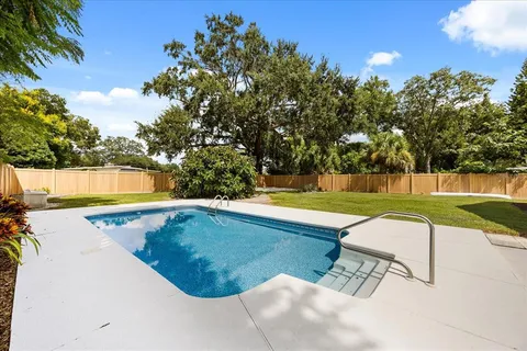 a view of a swimming pool with a yard