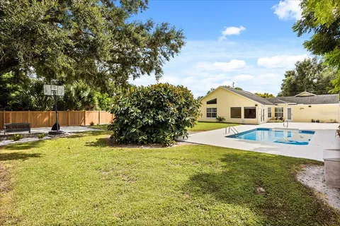 an aerial view of residential house with pool and yard