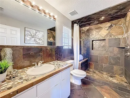 a utility room with sink dryer and washer