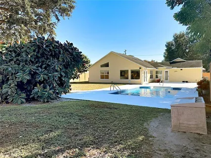 a view of yard with swimming pool and seating