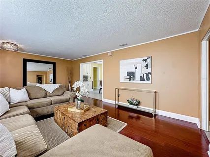 a living room with furniture and wooden floor