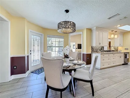 a view of a dining room with furniture and window