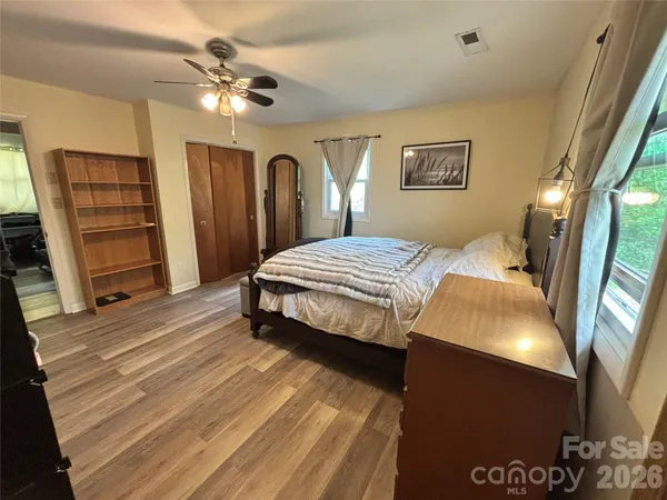 a bedroom with a bed and a chandelier