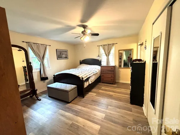 a bedroom with a bed and a chandelier