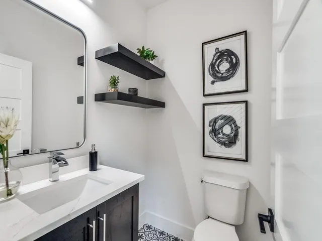 a bathroom with a toilet a sink and a mirror